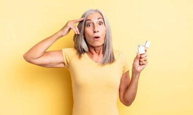 Orta yaşlı, güzel bir kadın mutlu, şaşkın ve şaşırmış görünüyor. daha hafif kavram