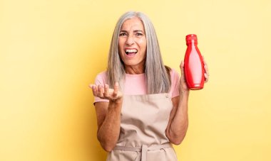 Orta yaşlı, güzel bir kadın umutsuz, sinirli ve stresli görünüyor. Ketçap konsepti