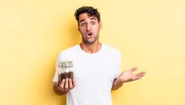 İspanyol yakışıklı adam inanılmaz bir sürprizle şaşkına dönmüş ve hayrete düşmüştü. Kahve şişesi.