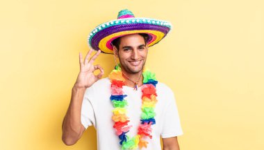 İspanyol yakışıklı adam kendini mutlu hissediyor, iyi bir jestle onaylıyor. Meksika partisi konsepti