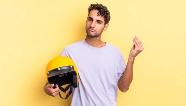 İspanyol yakışıklı adam kapiş ya da para hareketi yapıyor, sana ödemeni söylüyor. Motosiklet kaskı konsepti