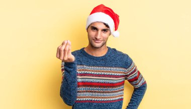 İspanyol yakışıklı adam kapiş ya da para hareketi yapıyor, sana ödemeni söylüyor. Noel konsepti