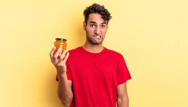 İspanyol yakışıklı adam kafası karışmış ve şaşkın görünüyor. Şeftali reçeli