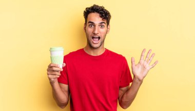 İspanyol yakışıklı adam kendini mutlu hissediyor ve inanılmaz bir şeye hayret ediyor. kahve konseptini kaldır.