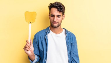 Hispanik yakışıklı adam üzgün, üzgün ya da kızgın hissediyor ve yana bakıyor. Sinekleri öldürür