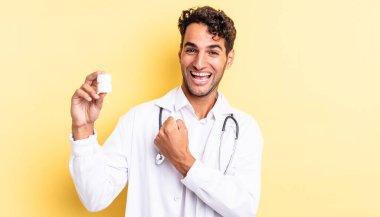 İspanyol yakışıklı adam kendini mutlu hissediyor ve bir meydan okumayla yüzleşiyor ya da kutluyor. Hekim şişesi hapları konsepti