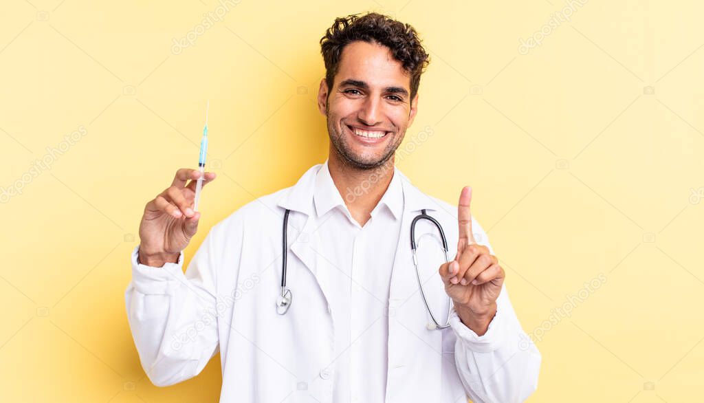 hispanic handsome man smiling proudly and confidently making number one physician and srynge concept