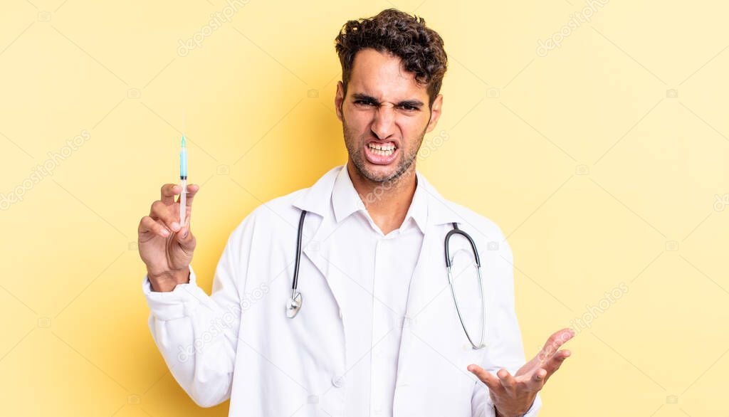 hispanic handsome man looking angry, annoyed and frustrated physician and srynge concept