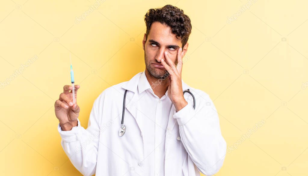 hispanic handsome man feeling bored, frustrated and sleepy after a tiresome physician and srynge concept