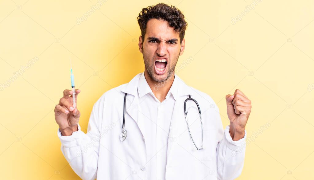 hispanic handsome man shouting aggressively with an angry expression physician and srynge concept