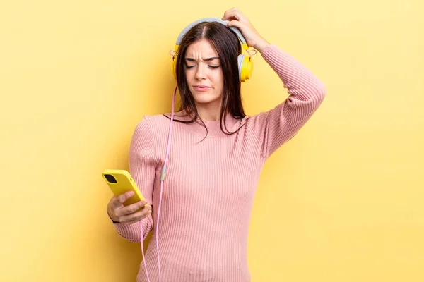 Young Hispanic Woman Smiling Happily Daydreaming Doubting Headphones Telephone Concept — Stock Photo, Image