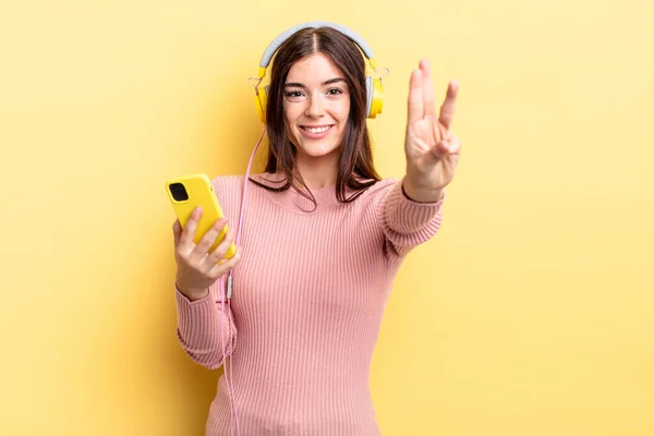 Young Hispanic Woman Smiling Looking Friendly Showing Number Three Headphones — Stock Photo, Image