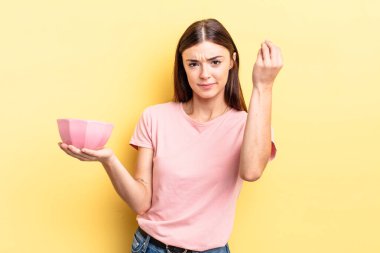 Genç İspanyol kadın kapiş ya da para hareketi yapıyor, sana ödemeni söylüyor. boş kase kavramı