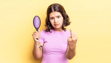 Genç İspanyol kadın kızgın, sinirli, asi ve agresif hissediyor. saç fırçası konsepti