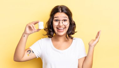 Genç İspanyol kadın kendini mutlu hissediyor ve inanılmaz bir şeye hayret ediyor. hastalık hapları konsepti