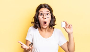 Genç İspanyol kadın inanılmaz bir sürprizle şaşkına dönmüş ve hayrete düşmüştü. hastalık hapları konsepti