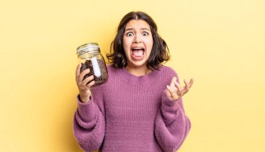 Genç İspanyol kadın umutsuz, hayal kırıklığına uğramış ve stresli görünüyor. kahve çekirdeği konsepti