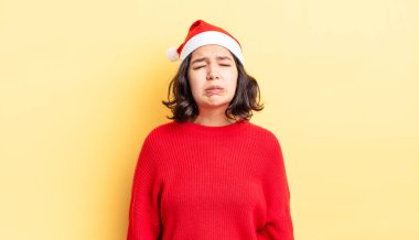 Genç İspanyol kadın üzgün ve mızmızlanıyor. Mutsuz bir bakışı var ve ağlıyor. Noel konsepti