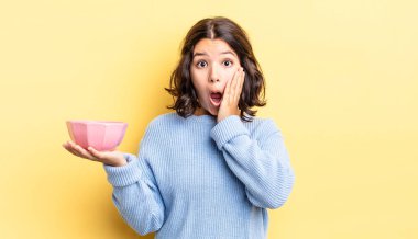 Genç İspanyol kadın şok olmuş ve korkmuş hissediyor. boş kase kavramı