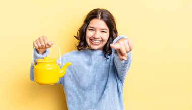 Genç İspanyol kadın kamerayı göstererek seni seçiyor. çaydanlık konsepti