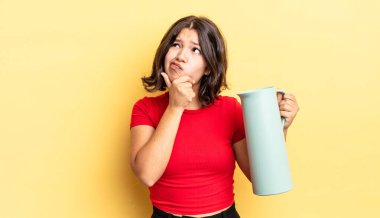 Genç İspanyol kadın düşünüyor, kuşkulu ve şaşkın hissediyor. termos kavramı