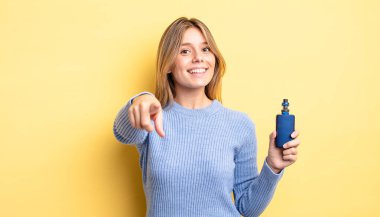 Güzel sarışın kız seni seçen kamerayı işaret ediyor. duman buharlaştırıcı kavramı