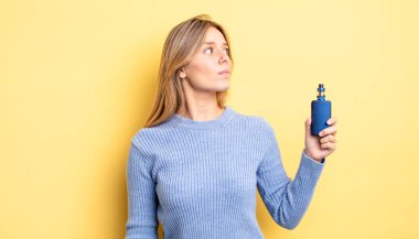 Profil görünümündeki güzel sarışın kız hayal mi kuruyor, hayal mi kuruyor yoksa hayal mi kuruyor? duman buharlaştırıcı kavramı