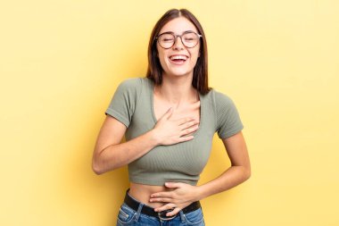 İspanyol güzel kadın komik bir şakaya yüksek sesle gülüyor, mutlu ve neşeli hissediyor, eğleniyor.