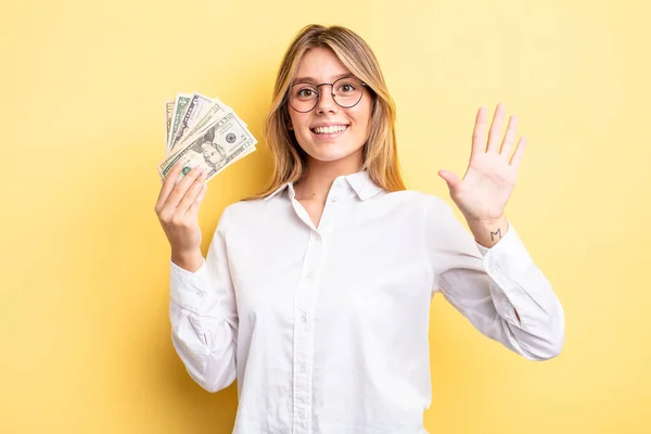 Pretty Blonde Girl Smiling Looking Friendly Showing Number Five Dollar — Stock Photo, Image