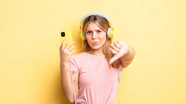 Pretty Blonde Girl Feeling Cross Showing Thumbs Listening Music Concept — Stock Photo, Image