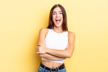 İspanyol güzel kadın mutlu, gururlu ve tatmin olmuş görünüyor. Kollarını kavuşturup gülümsüyor.