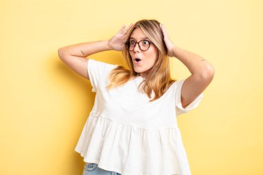 Sarışın, güzel, ağzı açık bir kadın korkunç ve şok olmuş görünüyor. Korkunç bir hata yüzünden, el ele tutuşuyor.