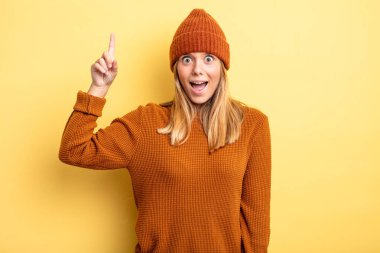 Sarışın, güzel bir kadın bir fikri fark ettikten sonra mutlu ve heyecanlı bir dahi gibi hissediyor. Neşeli bir şekilde parmağını kaldırıyor.!