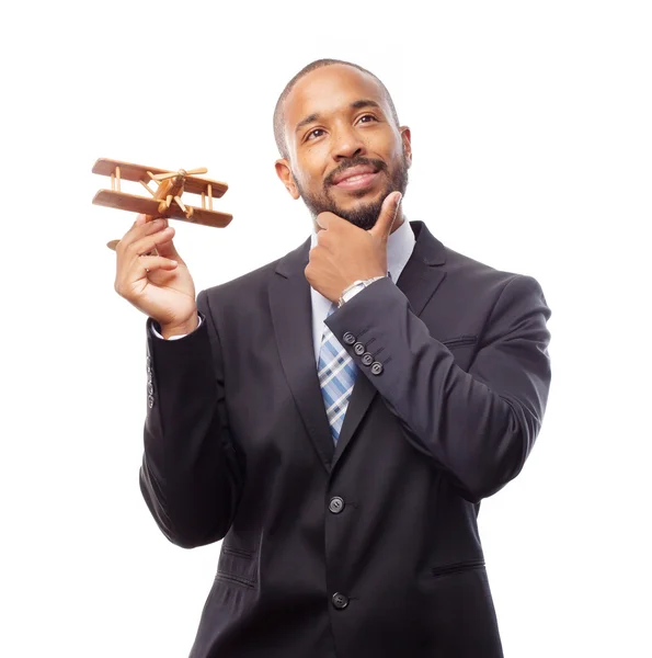 Young cool black man thinking with wooden plane — Stock Photo, Image