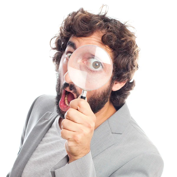 Young crazy man with magnifying glass Stock Photo