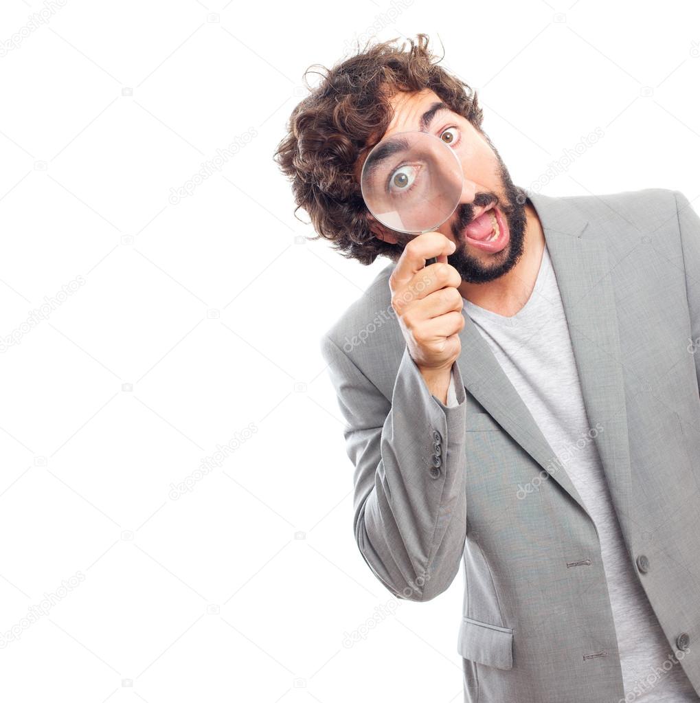 Young crazy man with magnifying glass