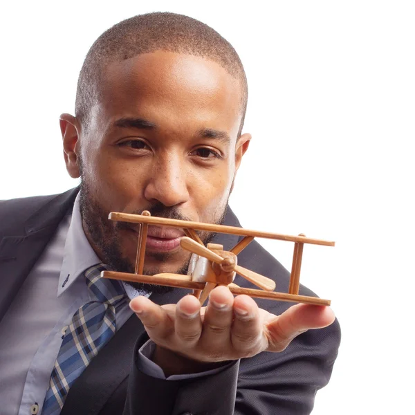 Young cool black man with wooden plane — Stock Photo, Image