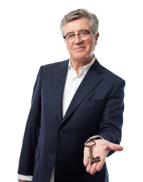 Senior cool man with an old key — Stock Photo, Image