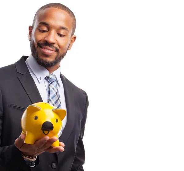 Young cool black man with a piggy bank — Stock Photo, Image