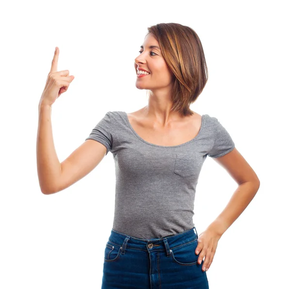 Joven cool mujer apuntando hacia arriba — Foto de Stock