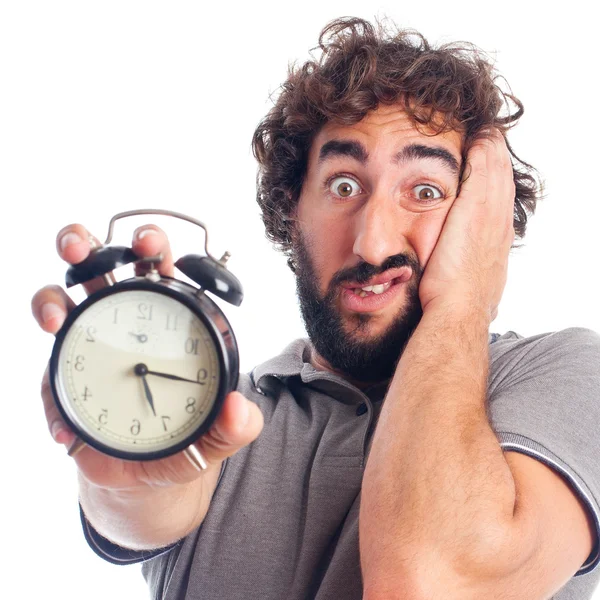 Young bearded man with a clock — Stock Photo, Image