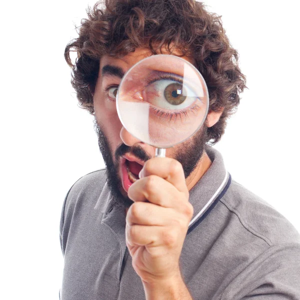 Young crazy man with a magnifier Royalty Free Stock Photos