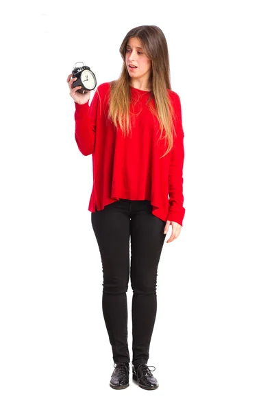 Young cool girl with an alarm clock — Stock Photo, Image