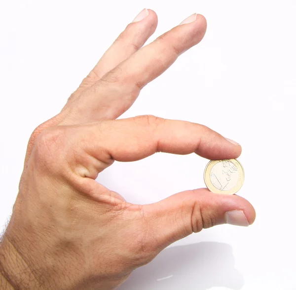 Mano con una moneda en euros — Foto de Stock