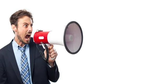 Jovem empresário louco com um megafone — Fotografia de Stock