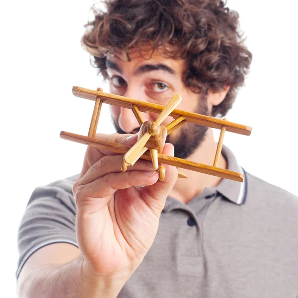 Young crazy man with a wooden plane — Stock Photo, Image