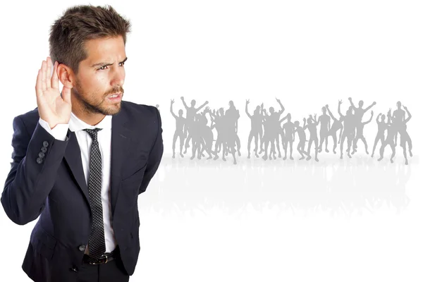 Businessman trying to listen on a crowd — Stock Photo, Image