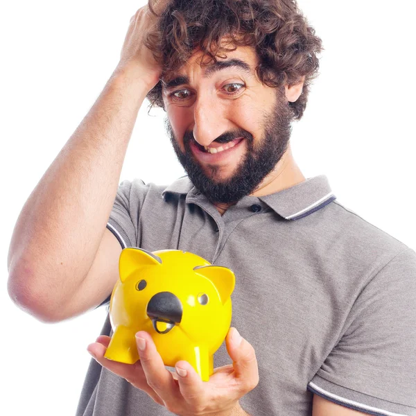 Jovem louco preocupado com um banco porquinho — Fotografia de Stock