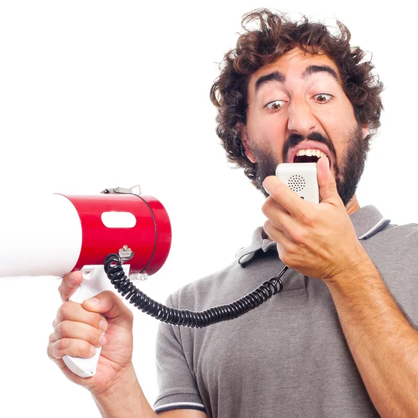 Young crazy man shouting with a megaphone — Stock Photo, Image