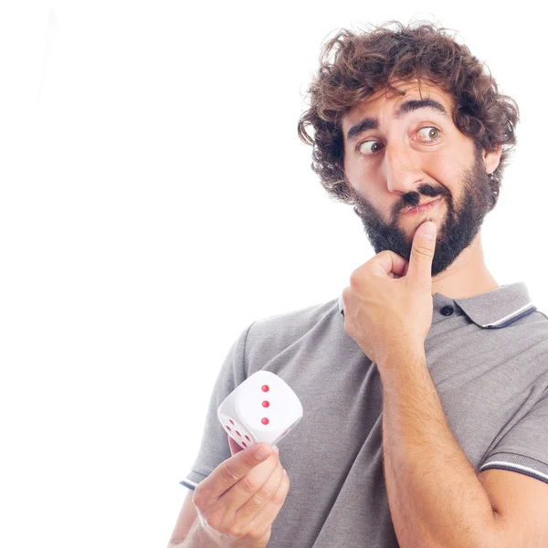 Young crazy man thinking with a dice — Stock Photo, Image